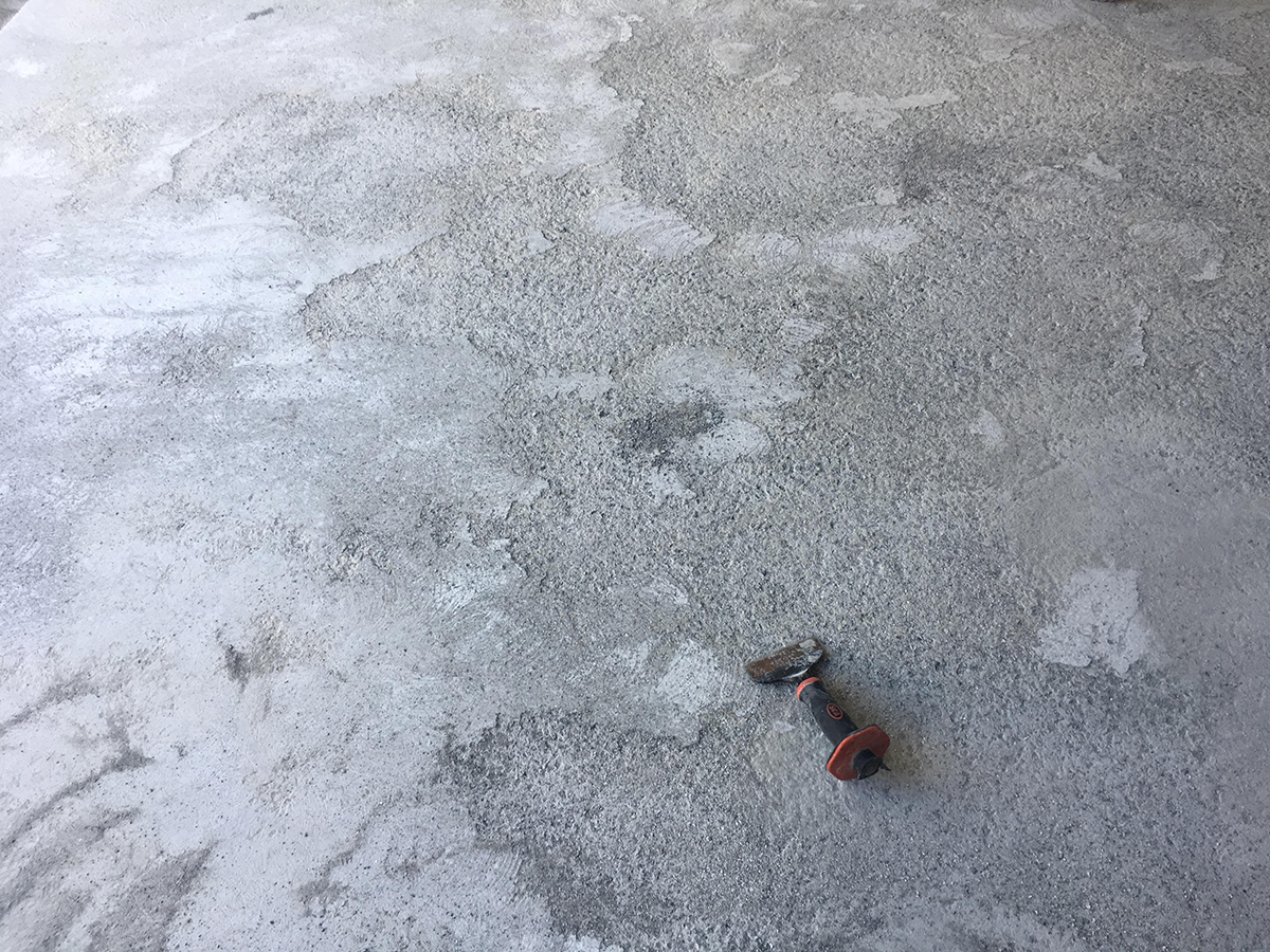 A concrete slab that looks very weak and porous and therefore not up to standard for resin flooring application.