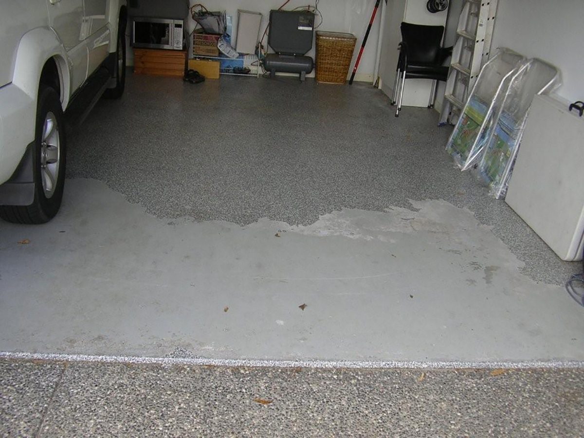 An existing floor coating that looks to have delaminated through poor adhesion.