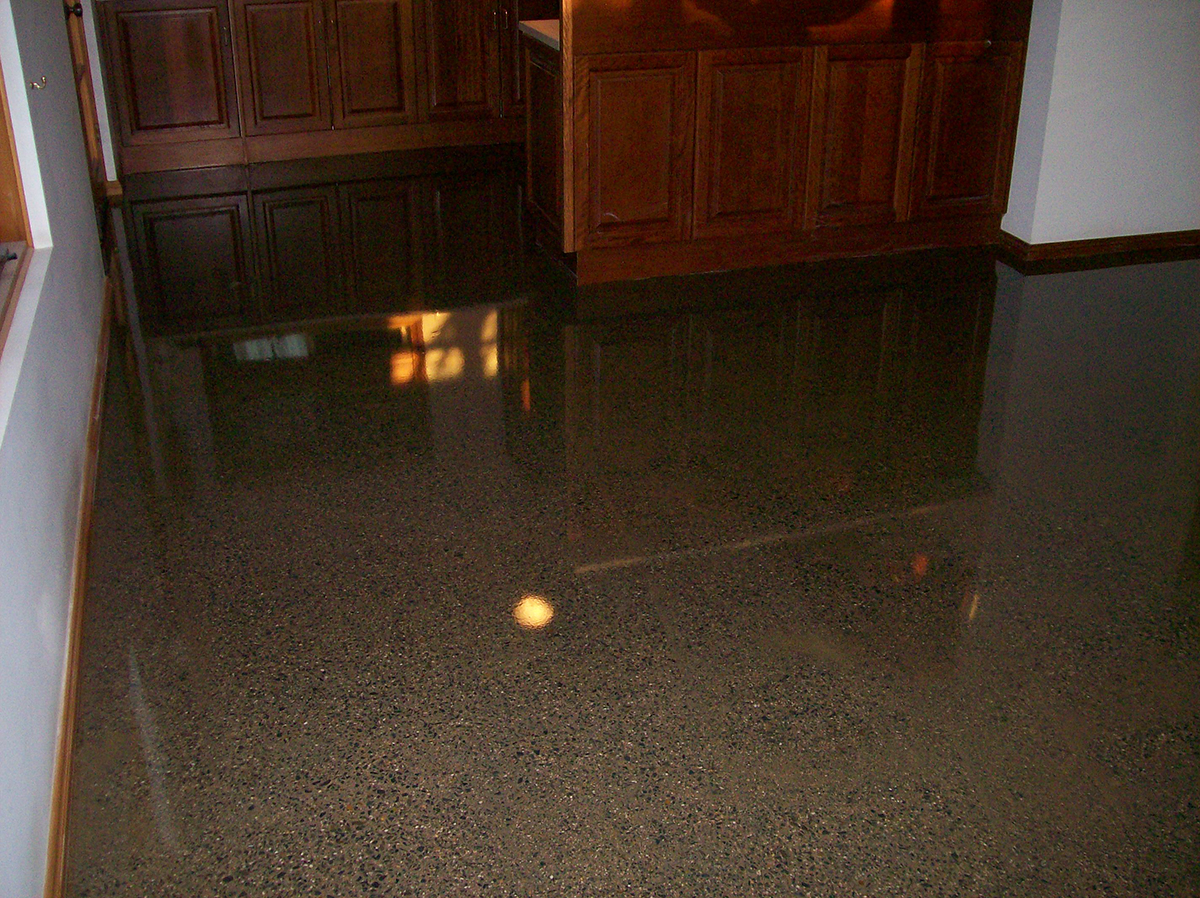 A clear epoxy resin used to create the polished concrete look in the living room of a home.