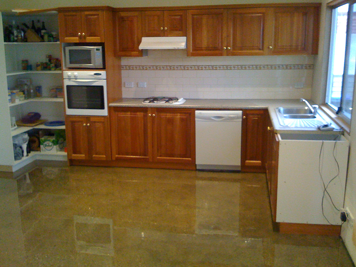 A residential kitchen applied a clear epoxy resin over the prepared concrete to give it a polished concrete look.