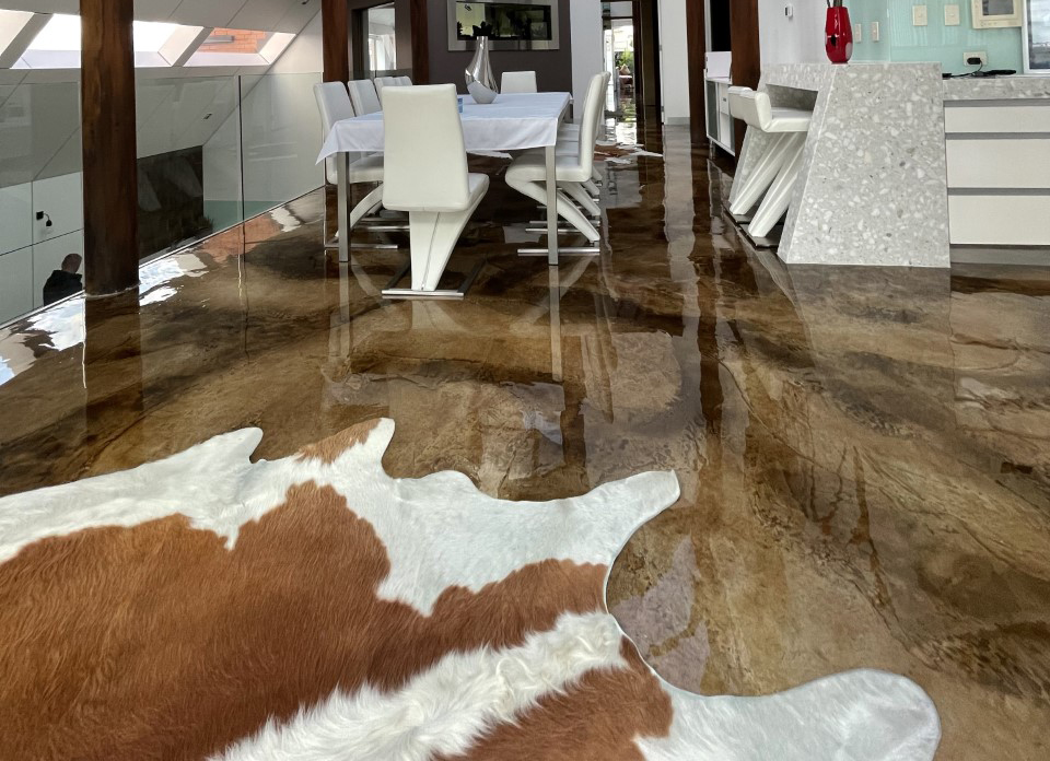 A photo showing the high-gloss clear epoxy resin finish in a residential living room.