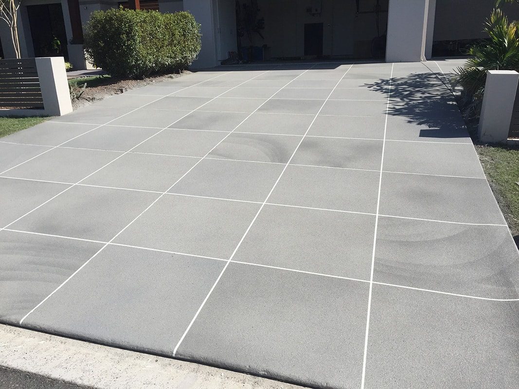 A driveway that has been resurfaced with a stenciled concrete finish.