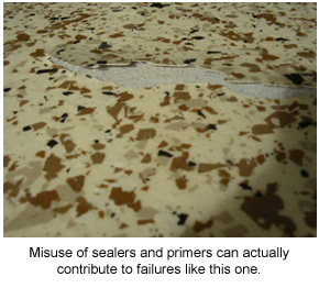 A flake floor in a garage cracking and lifting after the incorrect use of a primer.