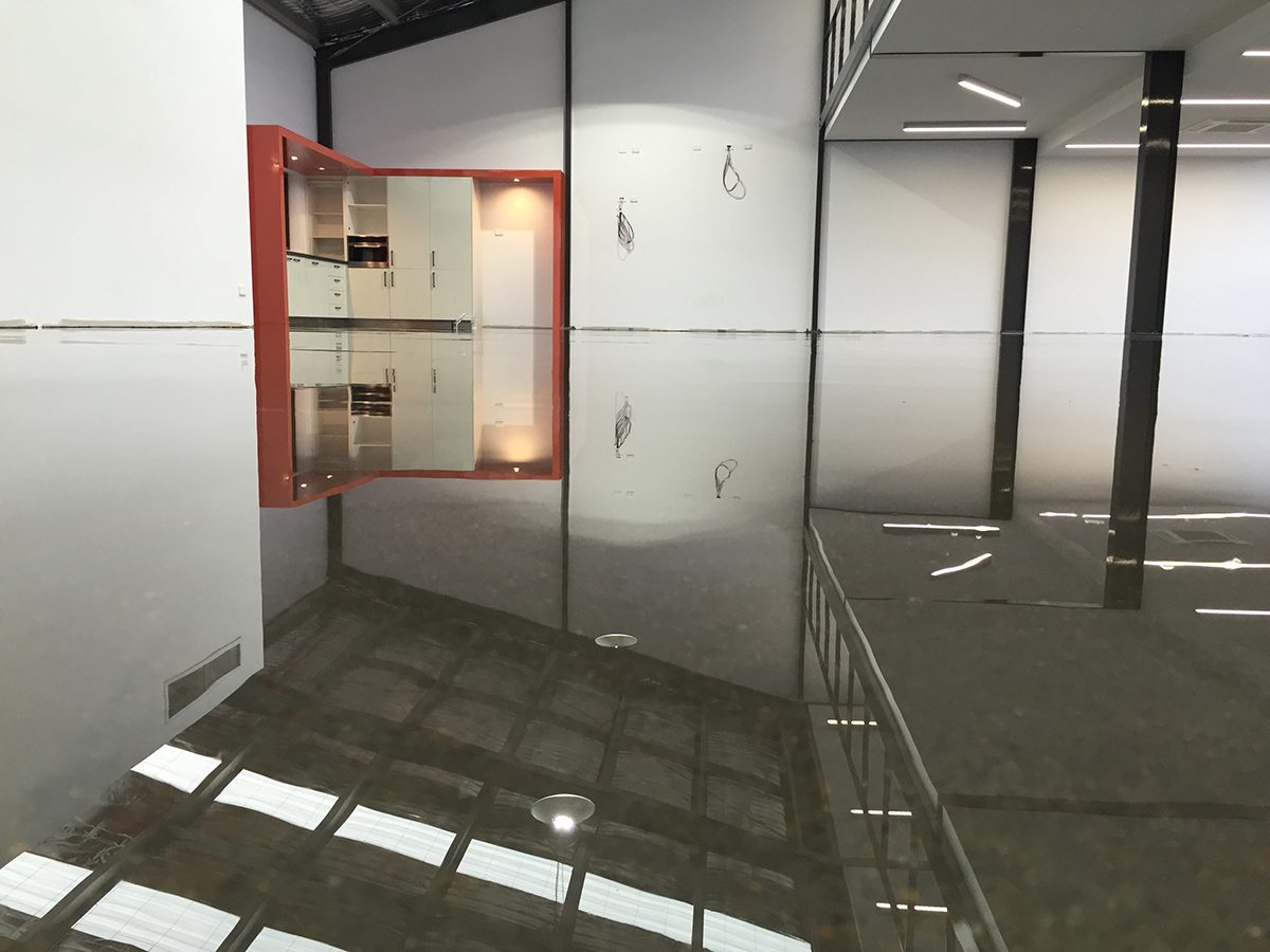 A low-angle photo of a clear epoxy floor that uses modifiers to achieve a flawless finish with no bubbles or other defects.