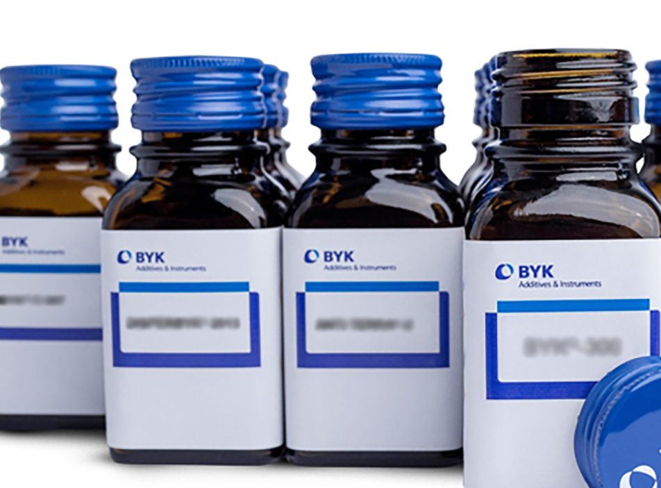 A collection of epoxy flooring additives and modifiers in sample jars.