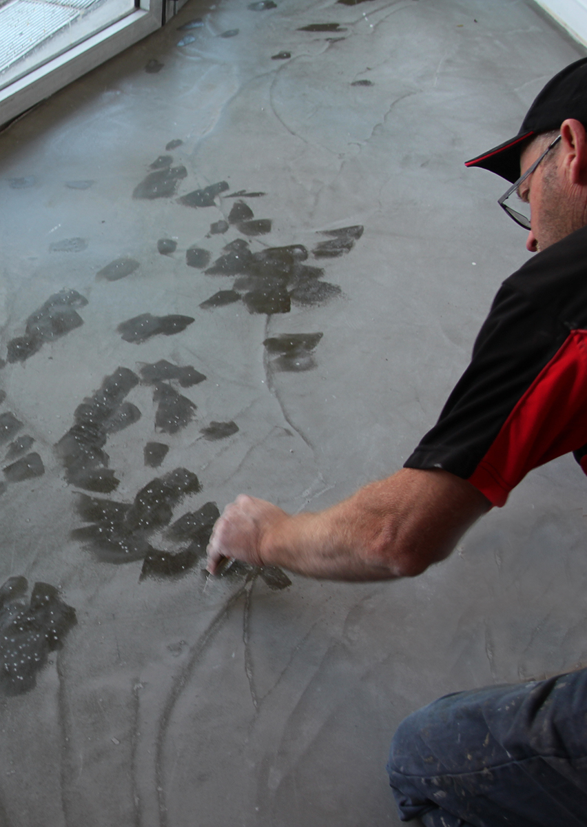 Fix in Five being used to patch pinholes in a levelling compound on the subfloor of a retail outlet.