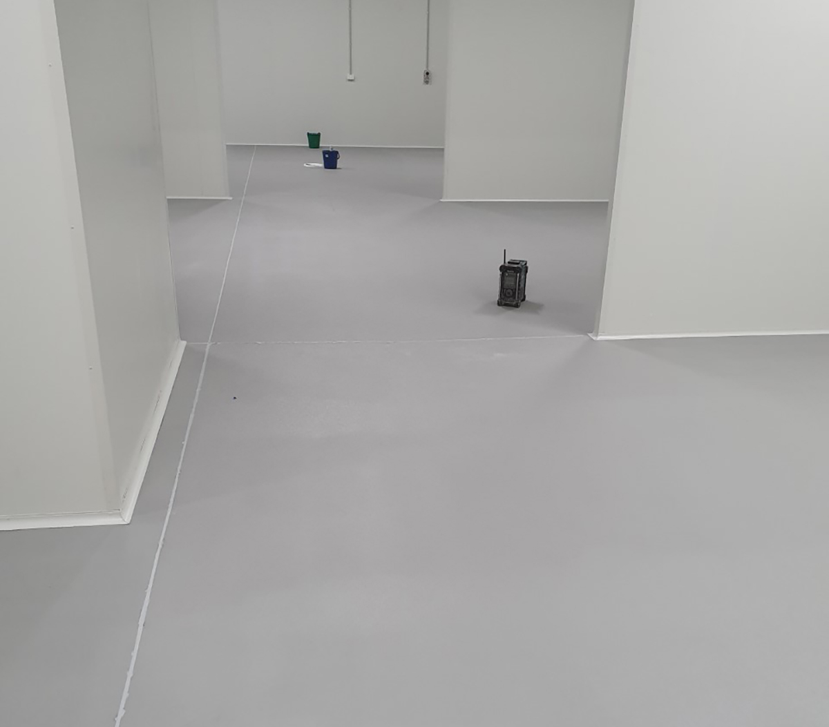 A room in a commercial kitchen that used Jaxxon industrial coatings on the floor and around the drains.