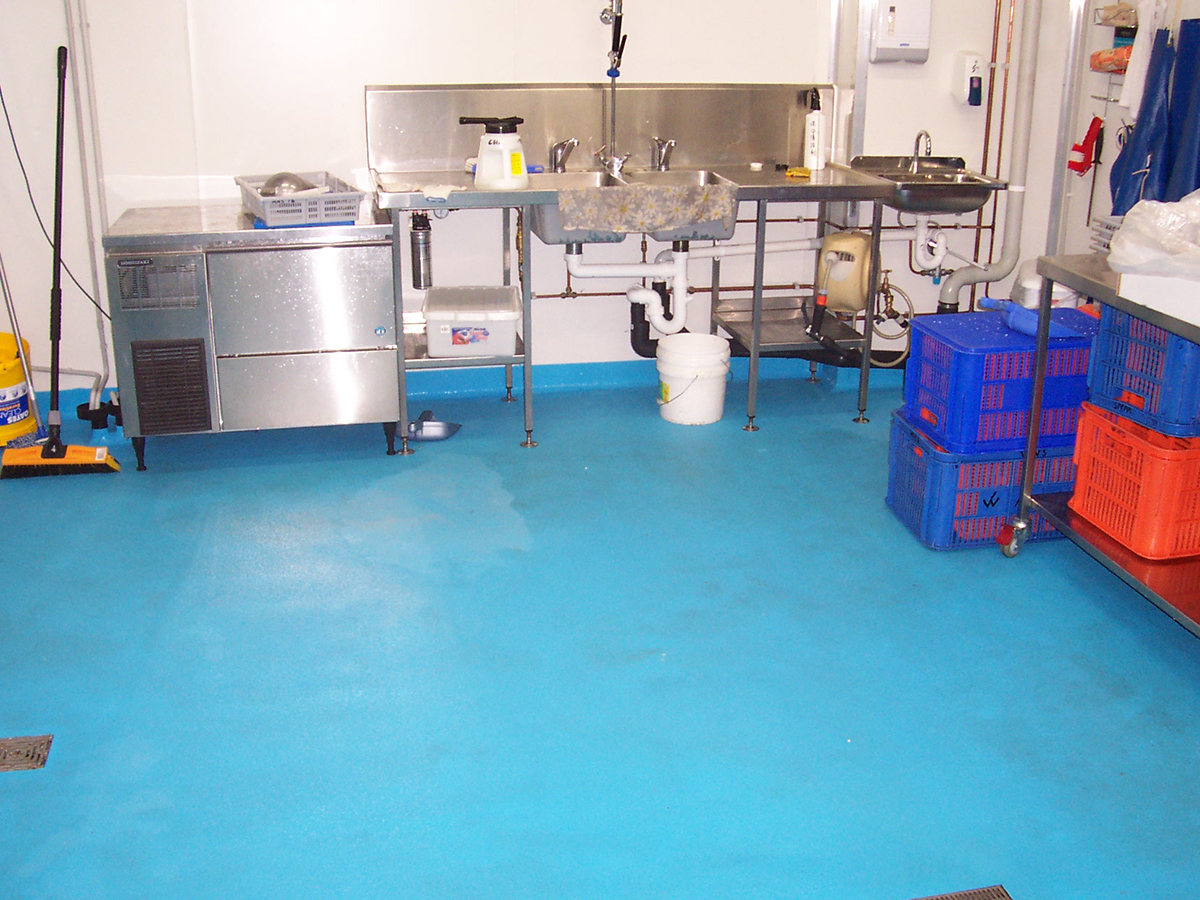 A light blue, non-slip industrial floor that used Jaxxon coatings in a food processing facility.