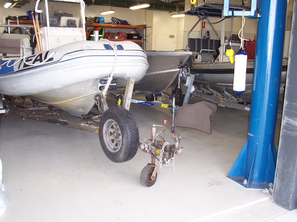 A boat sits on top of a Jaxxon industrial floor coating in a storage warehouse.