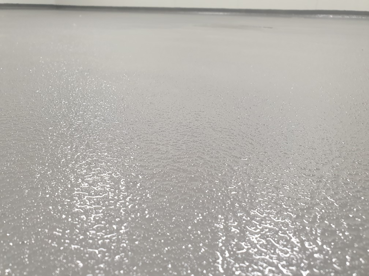 A low-angle shot in a food processing plant showing the texture of the non-slip industrial flooring system created with Jaxxon.
