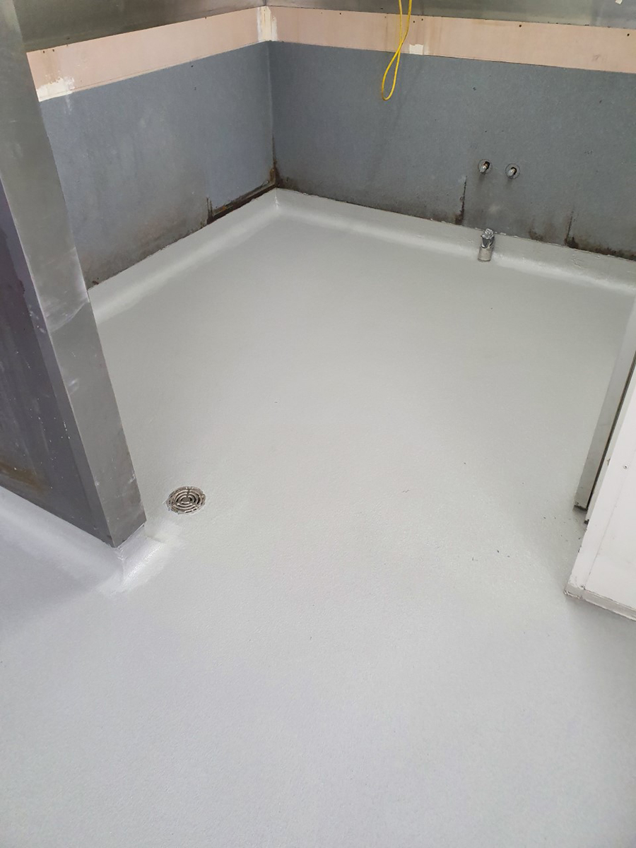 A room in a commercial kitchen that used Jaxxon industrial coatings on the floor and around the drains.