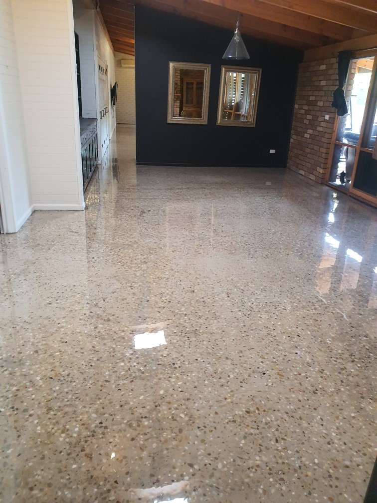 A clear epoxy used to create a beautiful polished concrete finish in a residential living room.