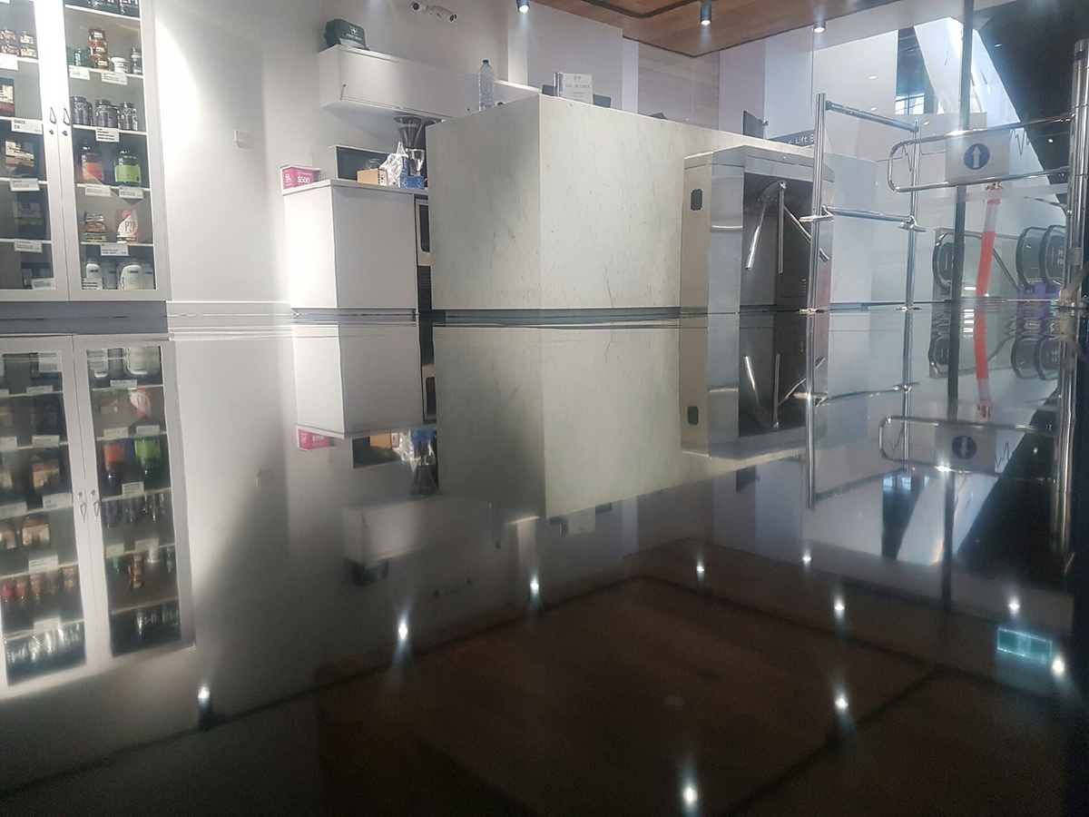 A low-angle shot looking across the foyer of a gym showing the beautiful, high-gloss finish of the clear epoxy resin used.