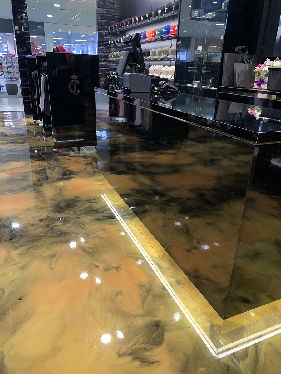 A clothing store used metallic pigments and Artepoxy Liquid Crystal to create a retail floor that matched their brand colours.