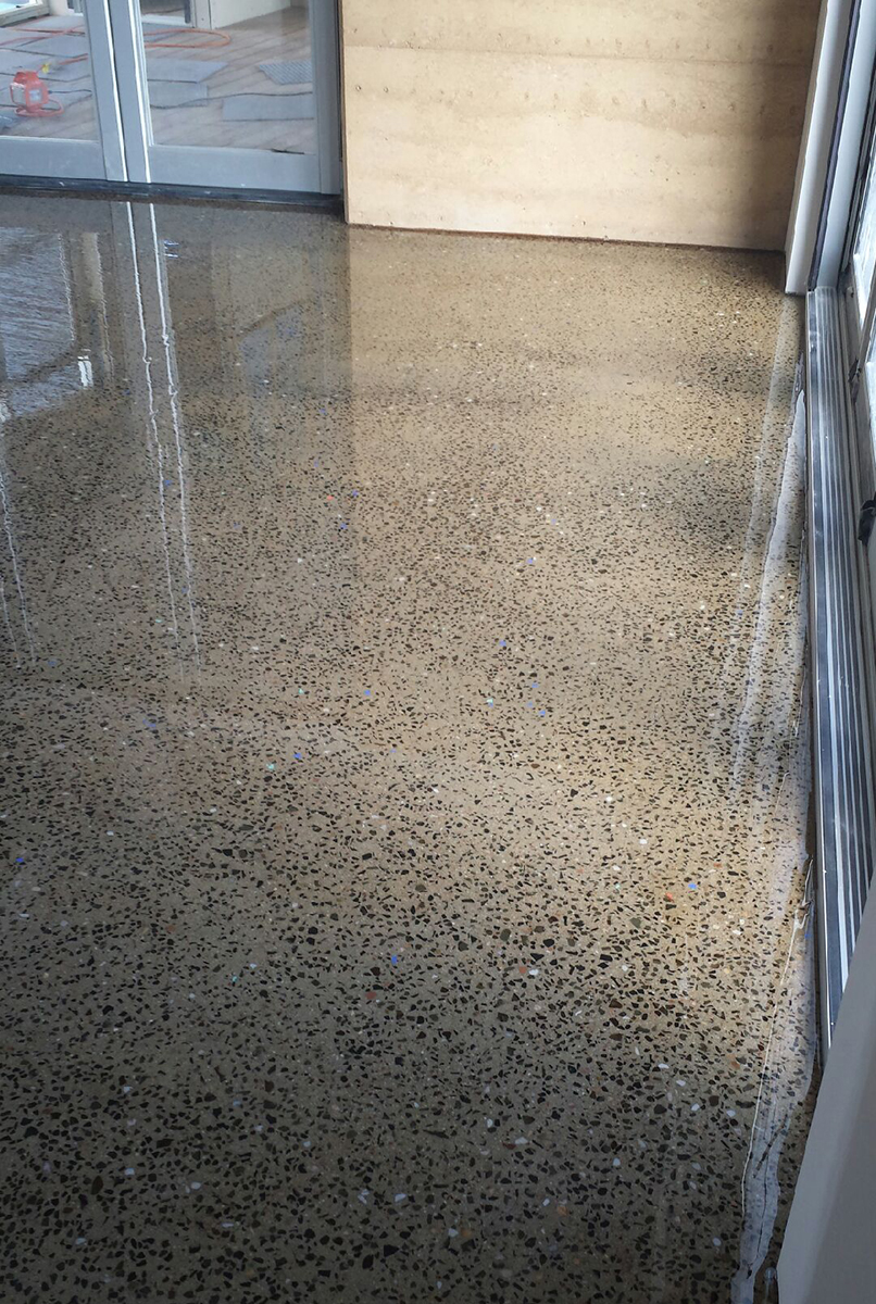 A close up of a commercial office space that used a clear epoxy resin to create the polished concrete look.