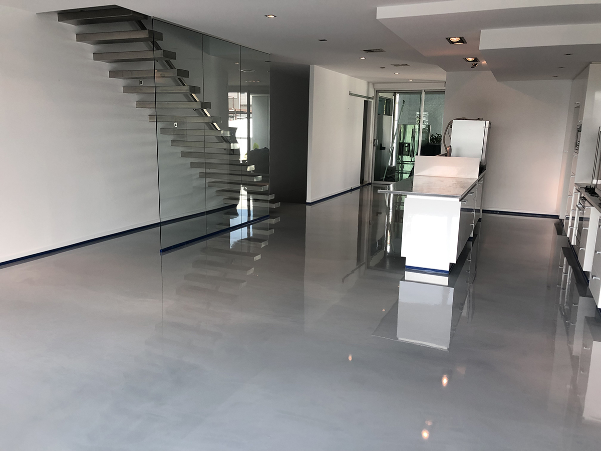 A stunning residential kitchen in an modern apartment with an iron grey marbled floor.
