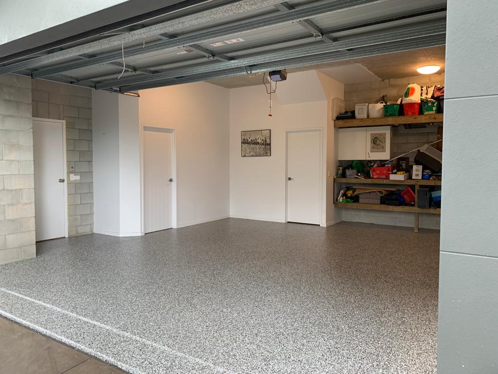 A photo taken from the front of an open garage showing the freshly applied garage floor coatings.