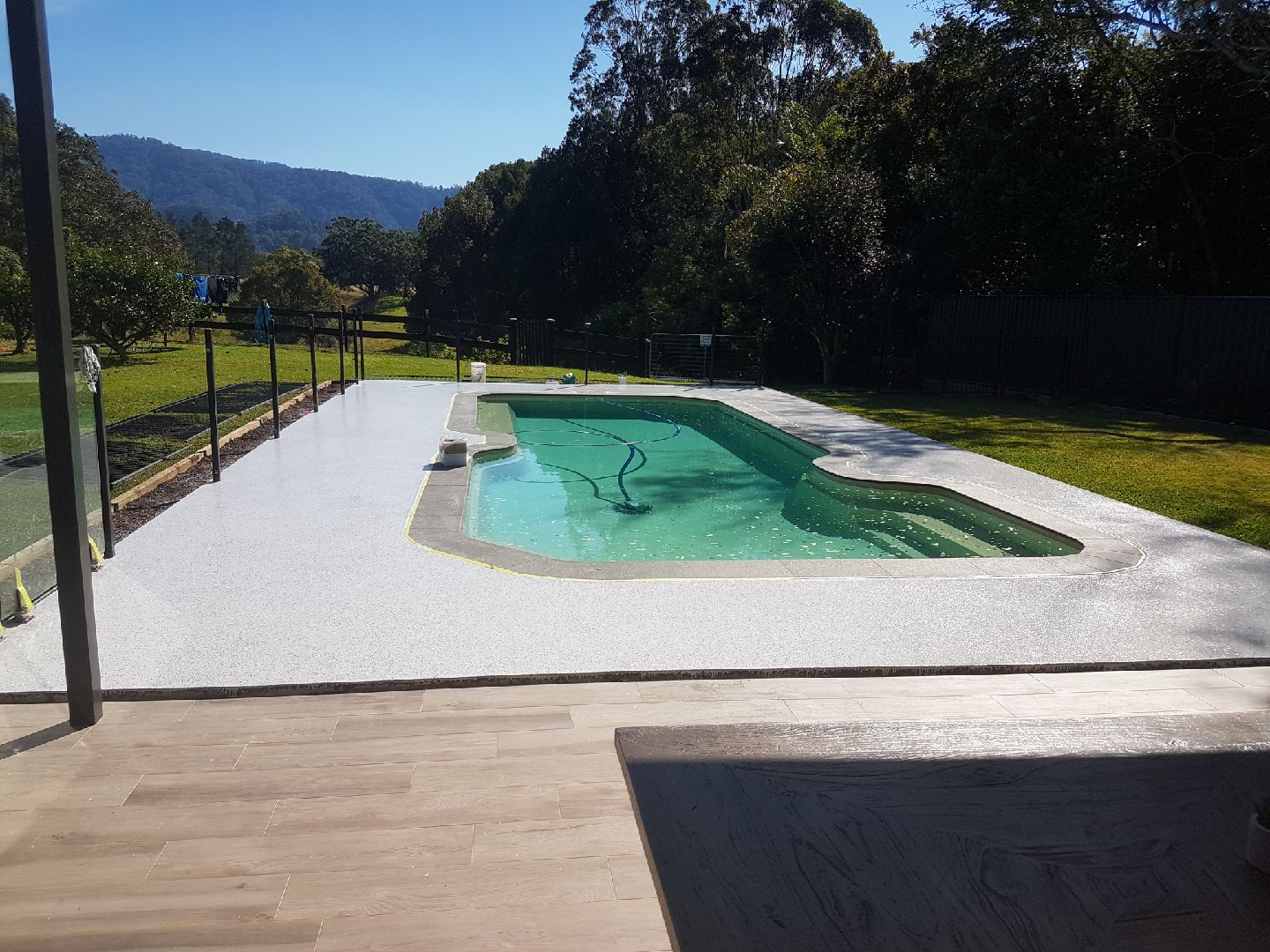 An epoxy flake floor applied around an outdoor pool area.