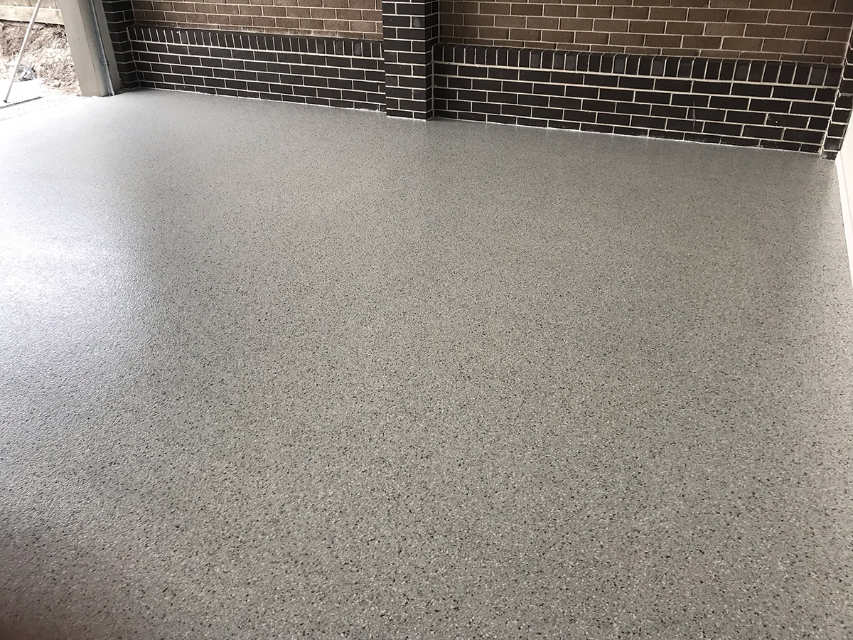 An epoxy flake floor in a residential garage with a beautiful, consistent finish.