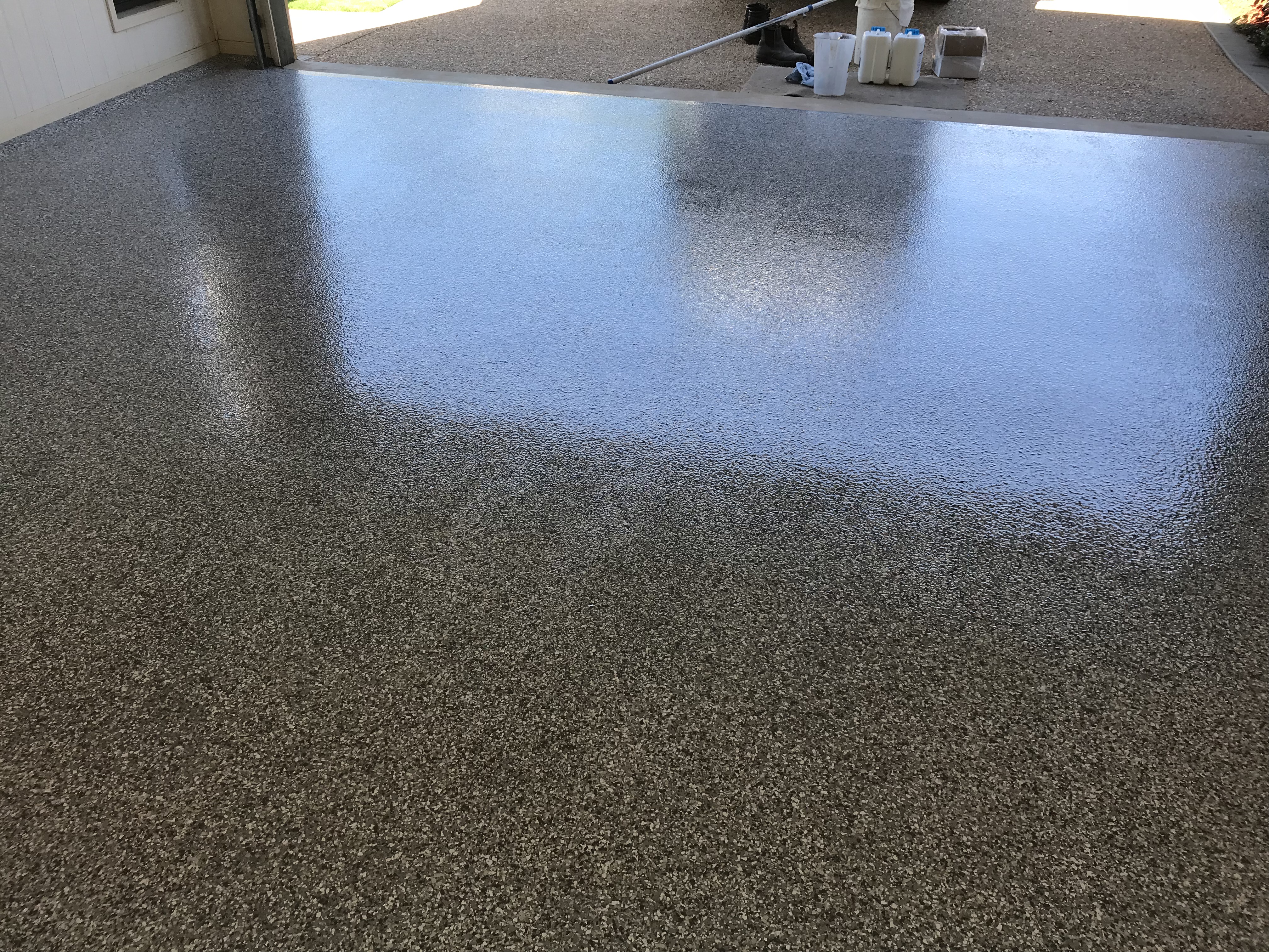 A low-angle photo of an epoxy flake floor showing the beautiful, even finish.