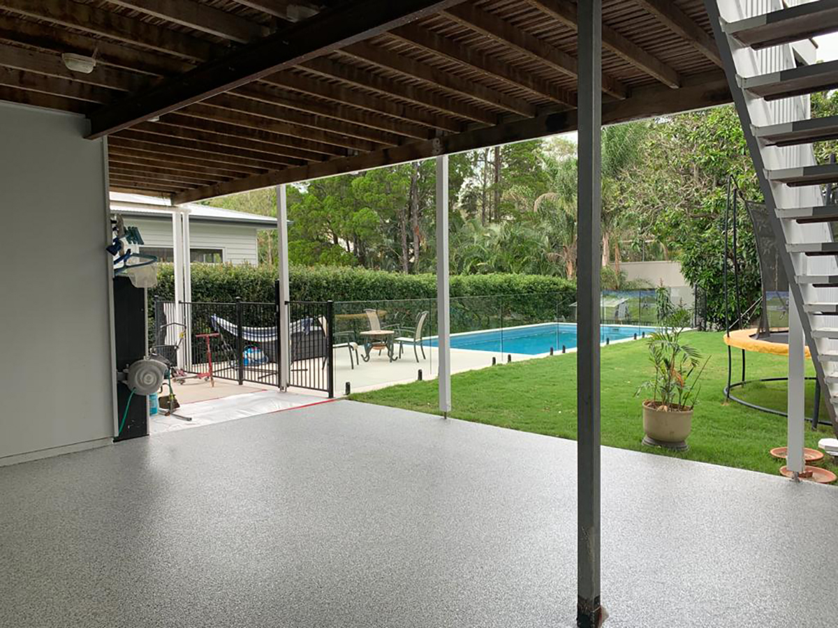 A beautiful outdoor entertainment area of a home looking magnificent after a flake epoxy floor was installed.