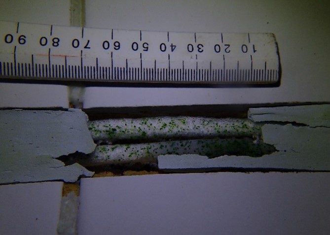 A section of the original expansion joint in the swimming pool that had deteriorated and needed to be replaced.