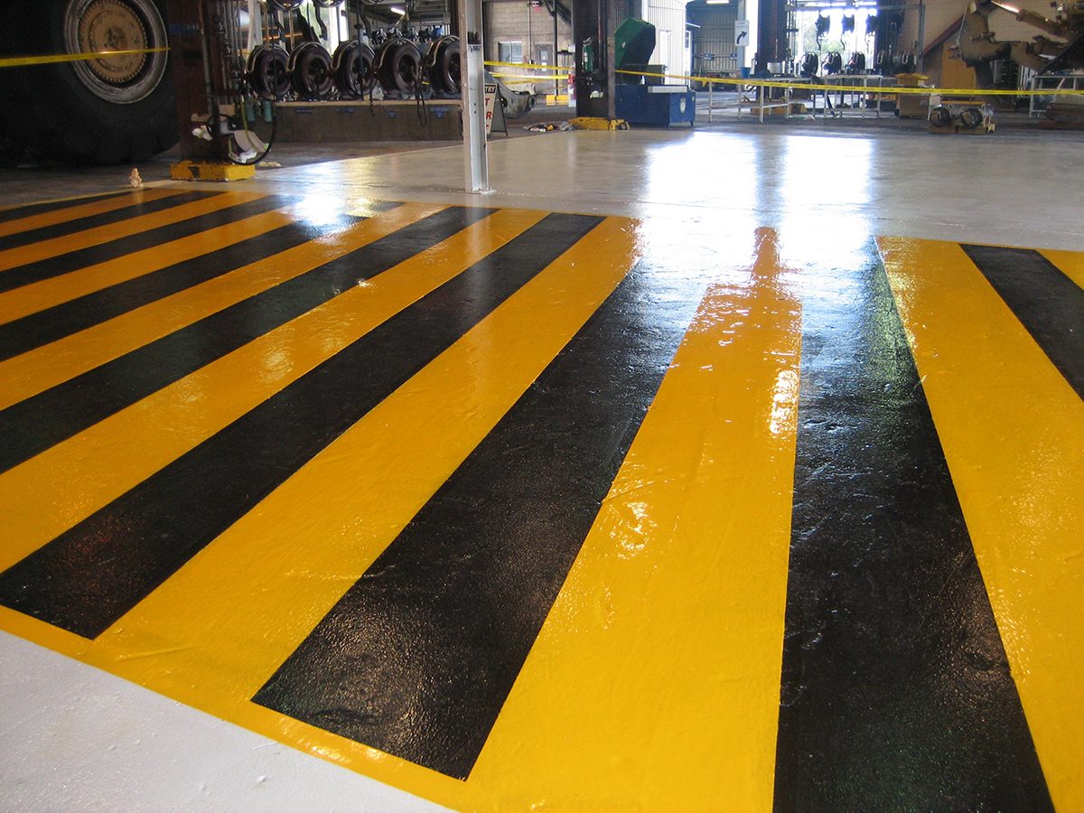 A photo taken at the completion of the project showing a close up of the black and yellow linemarking that was required in the workshop.