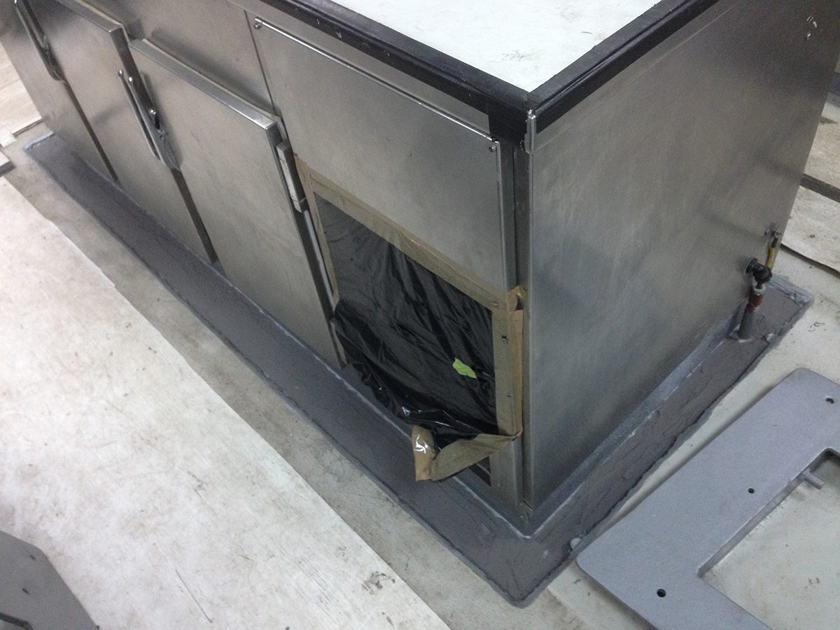 An area around a steel bench in the galley that had the previous flooring removed.