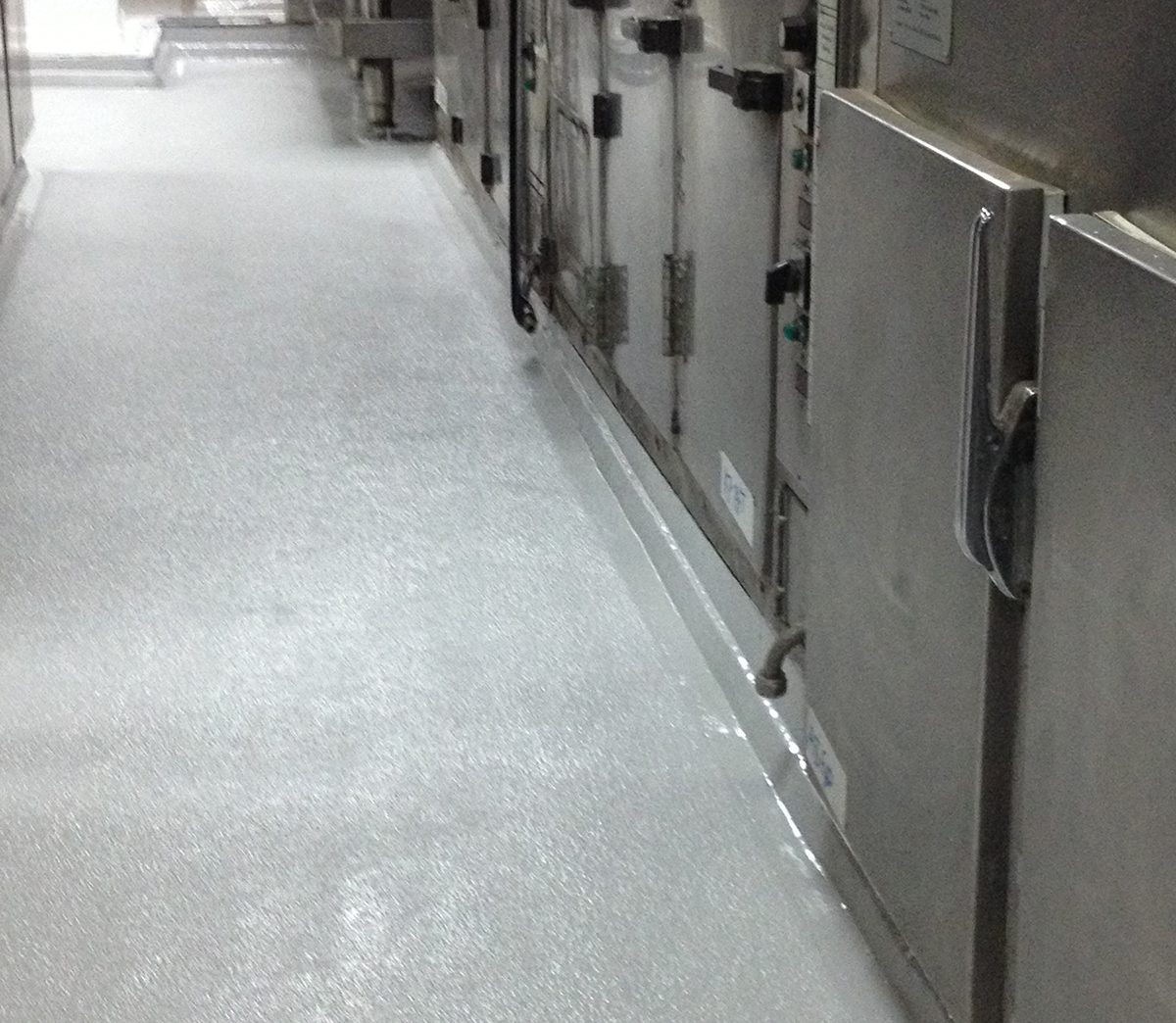 The steel cabinets that line one of the walkways in the galley onboard HMAS Darwin.