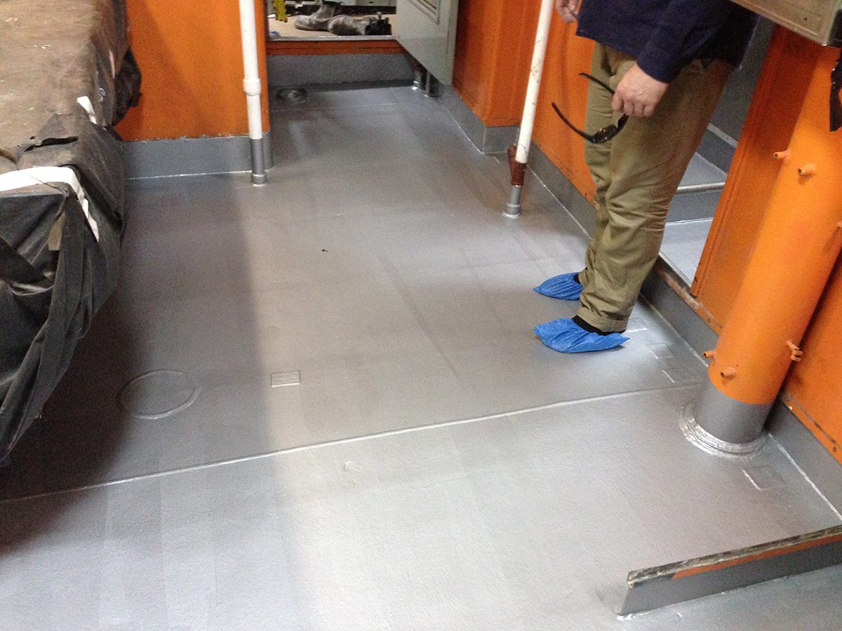 A photo taken before the project with the steel deck primed and ready for installation of the wet-space flooring system.