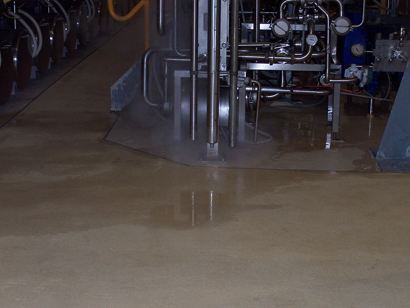 A liquid spill on an industrial epoxy floor in a processing plant.