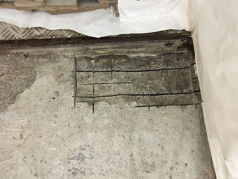Badly damaged concrete in a pump house with the rebar exposed.