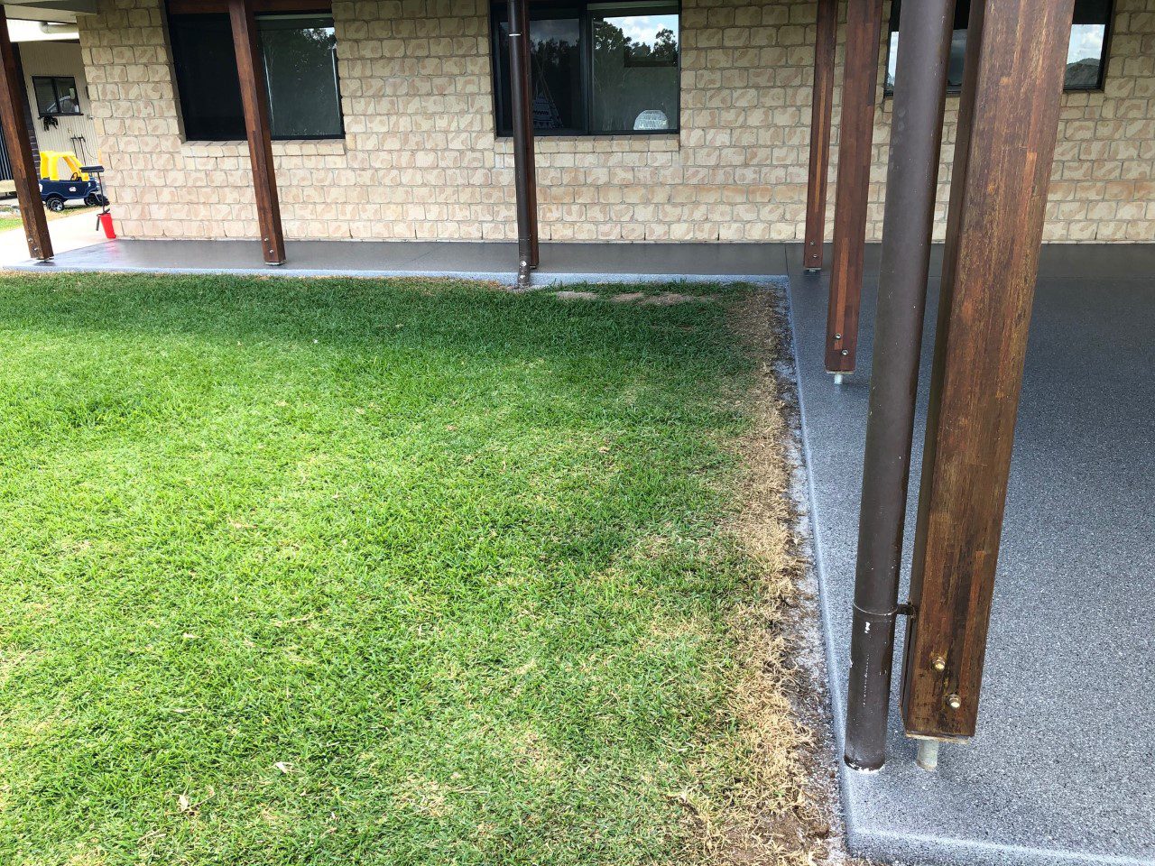 A view of the new flake floor from the front of the patio, looking towards the other side of the house.