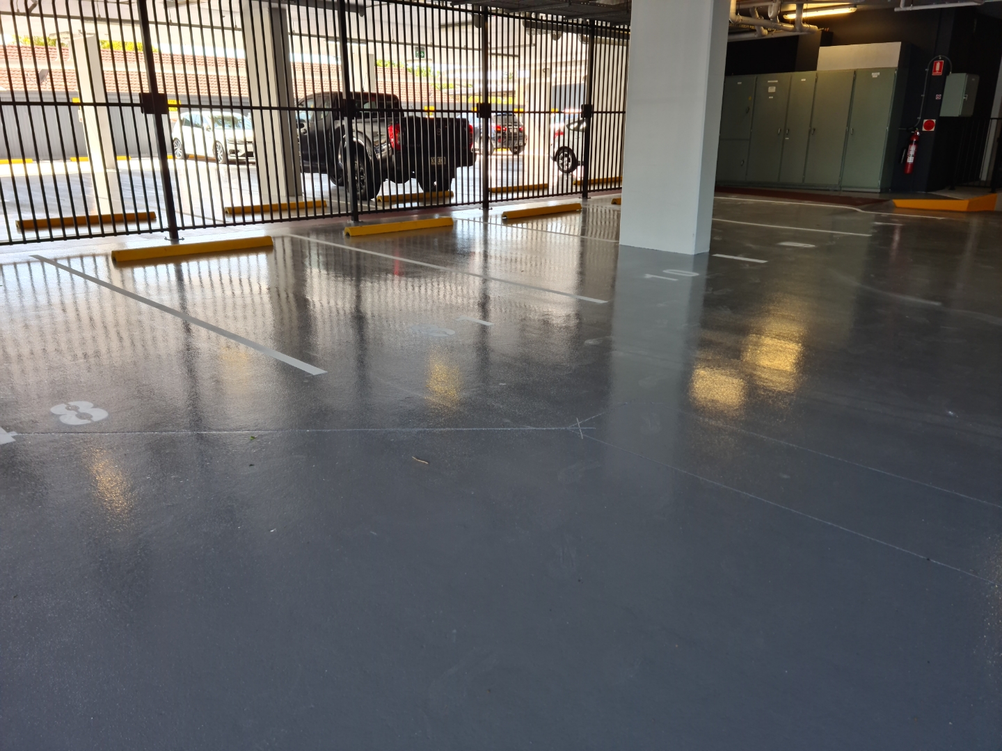 A view of the empty warehouse from the open front door showing the new protective epoxy floor covering the large area.