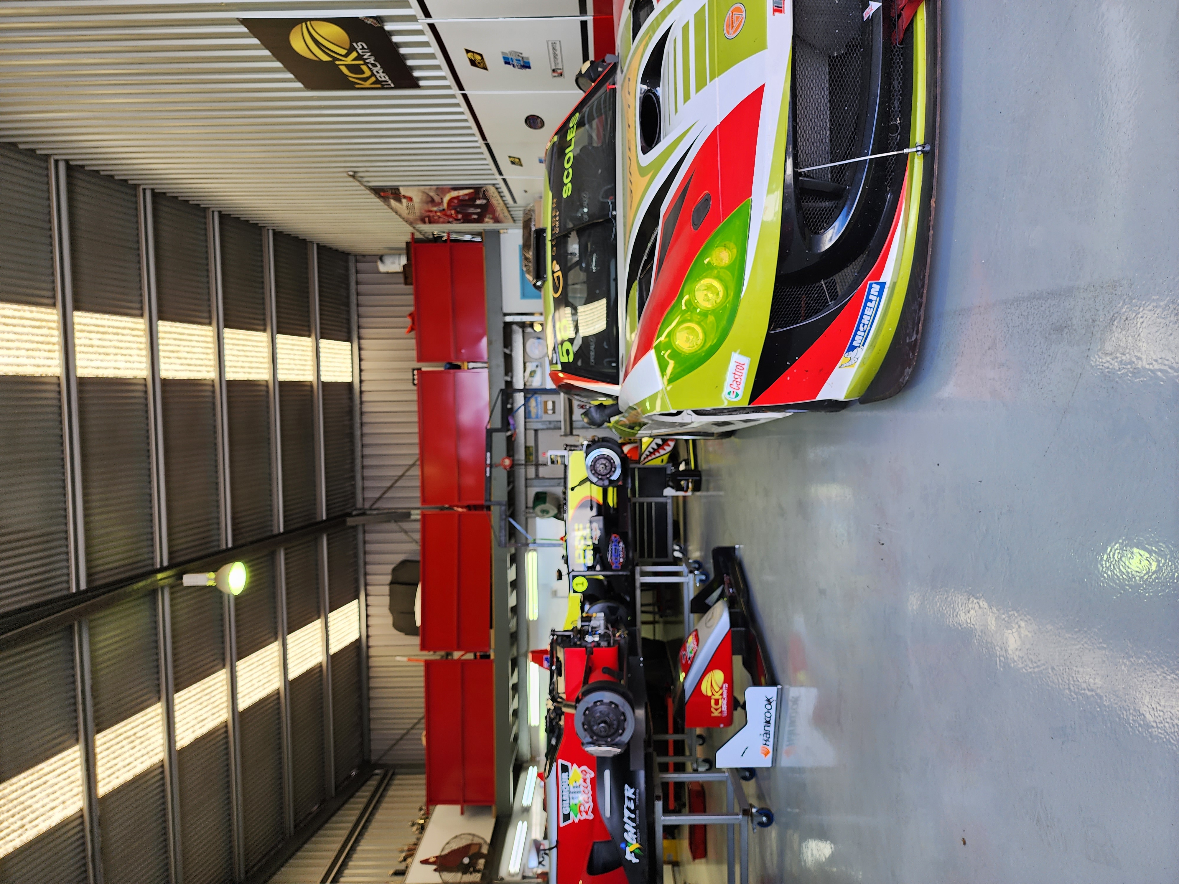 Another angle of the new protective epoxy floor showing the front roller door and the office off to the side.