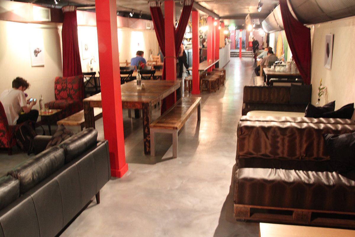 A photo taken from the back of the cafe looking towards the entrance, showing the clean, modern look the new silver metallic epoxy floor provided.