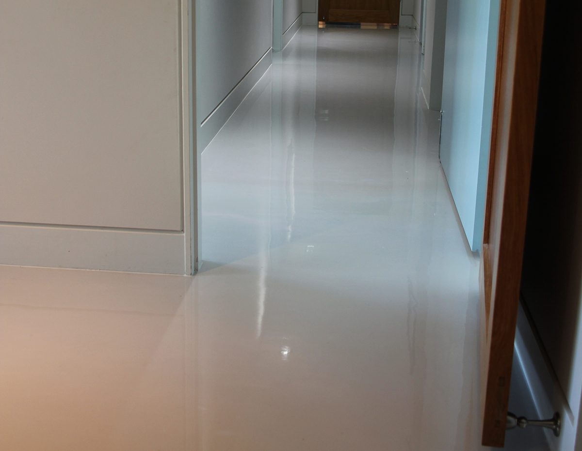The hallway that connected the downstairs bedrooms after the new, high-gloss metallic floor was installed in a pearl colour.