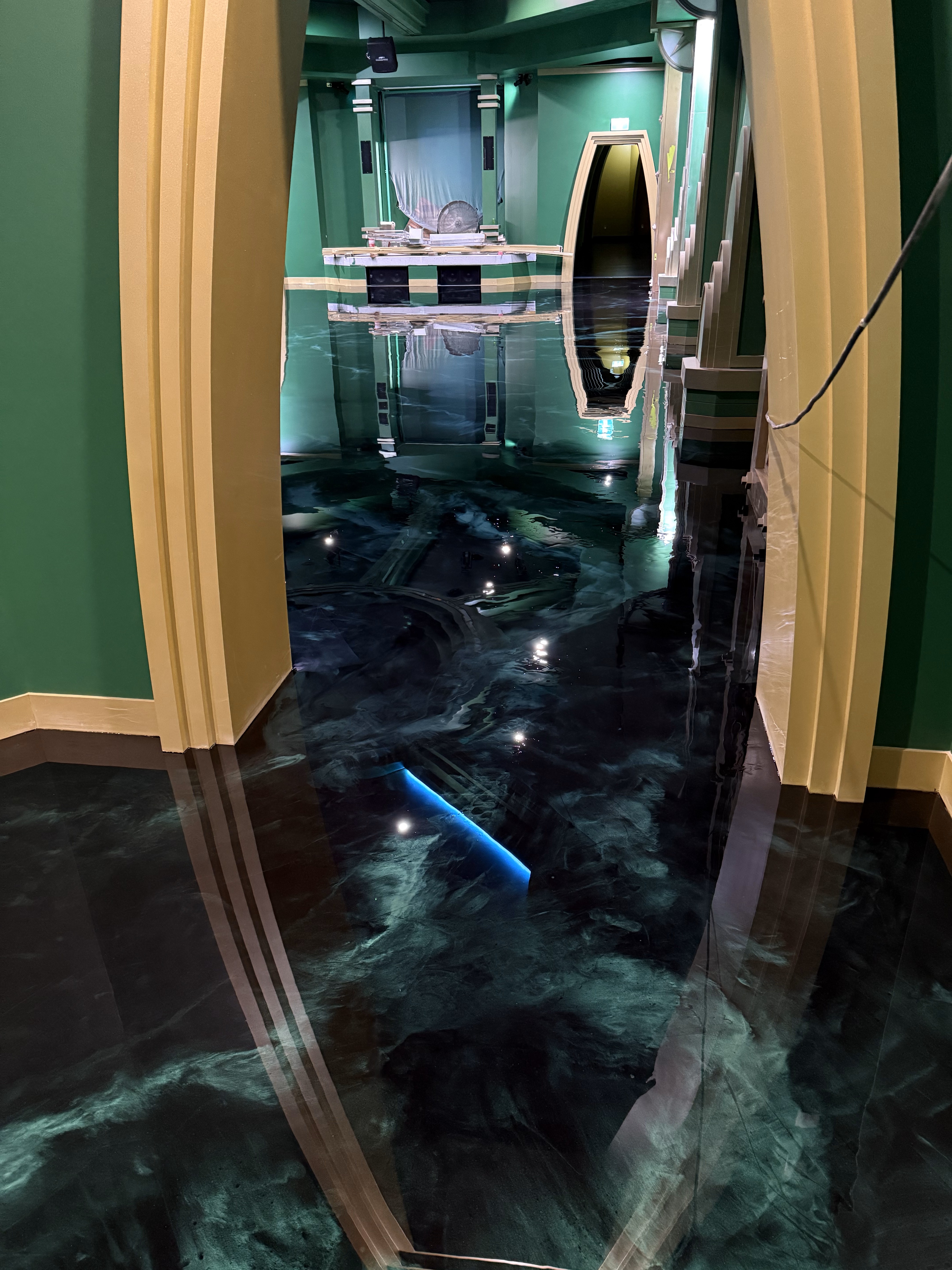 A photo taken from the cafe entrance looking into the cafe, with the seating area in the background and a decorative wooden barrel in the left foreground.