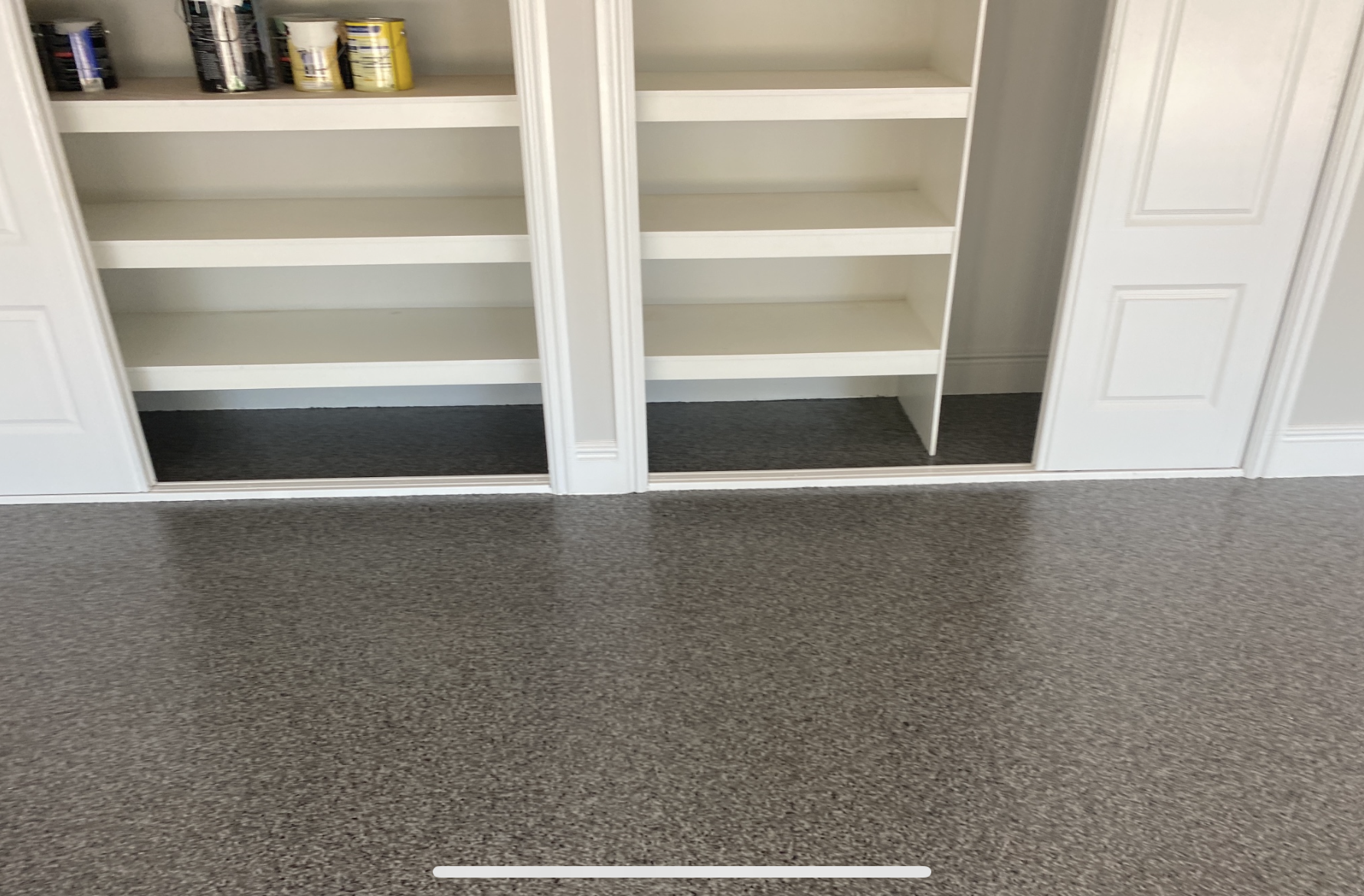 Another angle of the front of the residential garage with the smiling homeowner and her daughter standing at the opening.