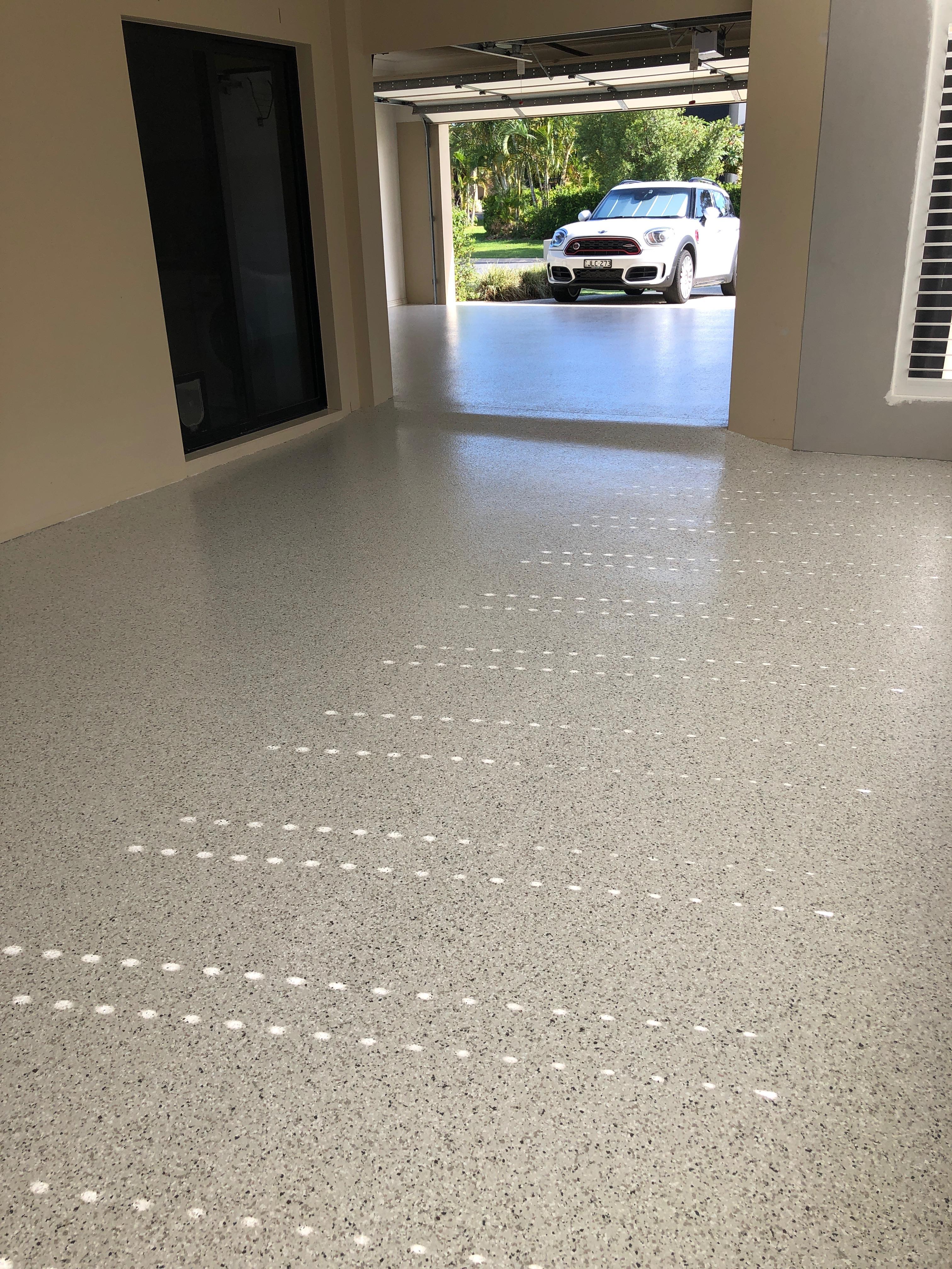 The new flake floor stretching across the garage and into the connecting sunroom that was added during recent renovations.