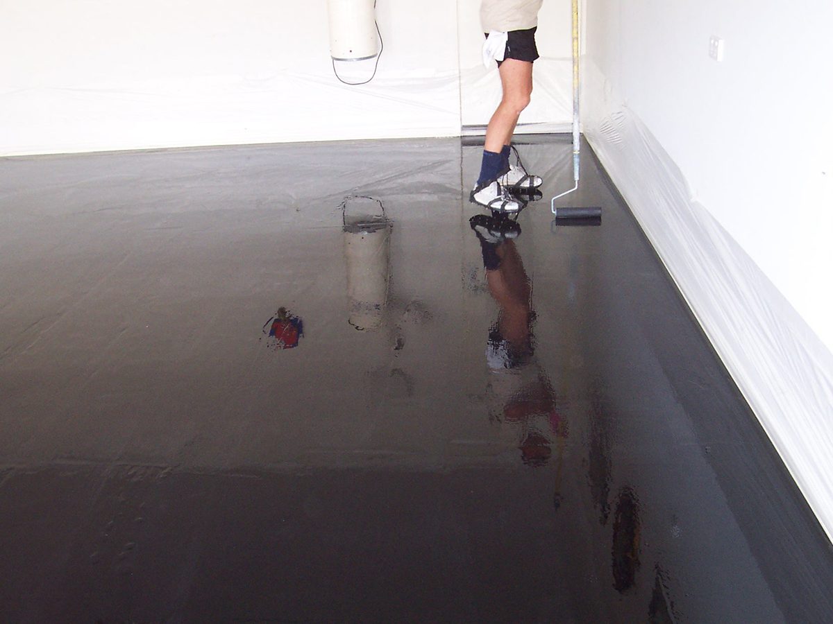 A one-man epoxy flooring business in the middle of applying an epoxy floor.